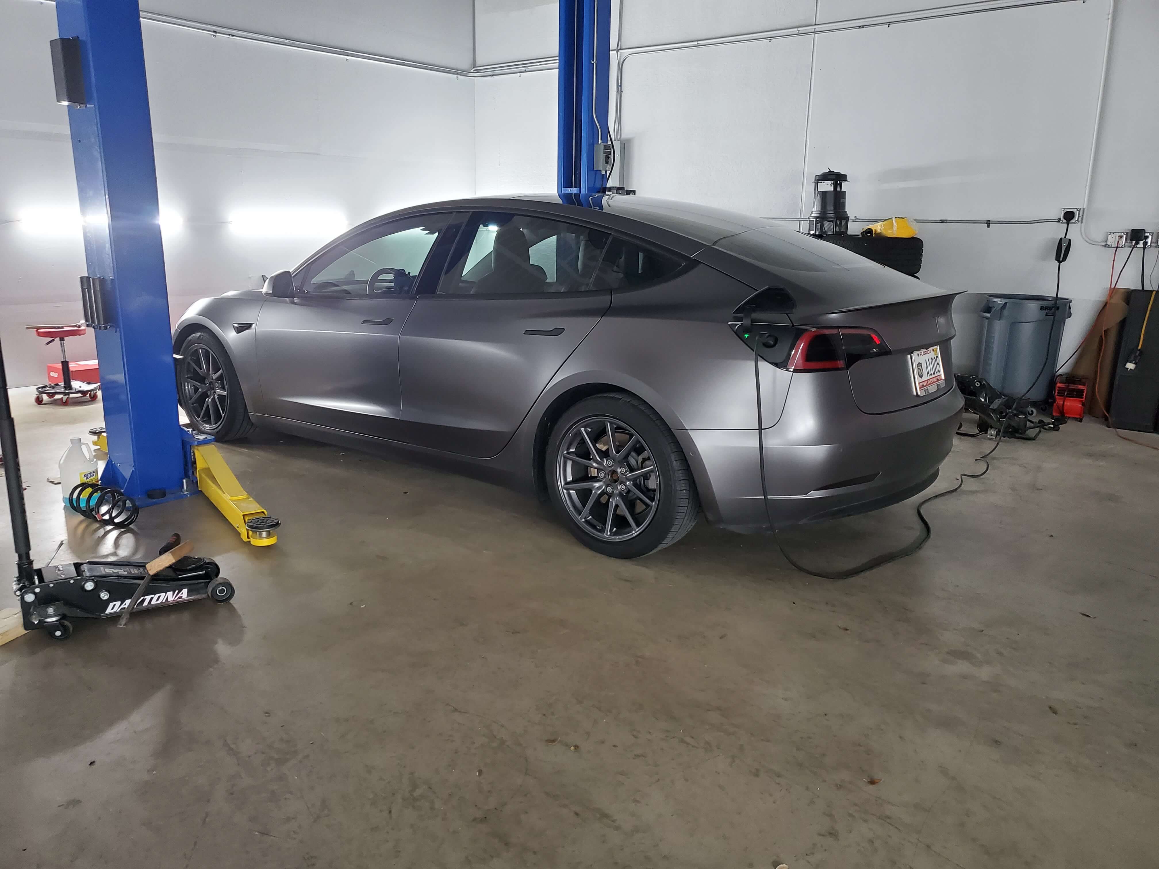 electric vehicle being charged at repair shop